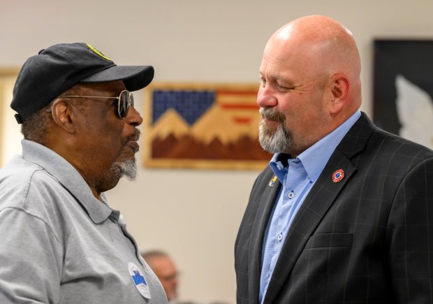 Wallace Lee of Palmer Township speaks with Bob Brooks on June 3, 2026, during a general election kickoff event in Whitehall Township for Bob Brooks' congressional campaign. Brooks, a Democrat and former Bethlehem firefighter, is challenging Republican Rep. Ryan Mackenzie to represent the Lehigh Valley's 7th District. (April Gamiz/The Morning Call)