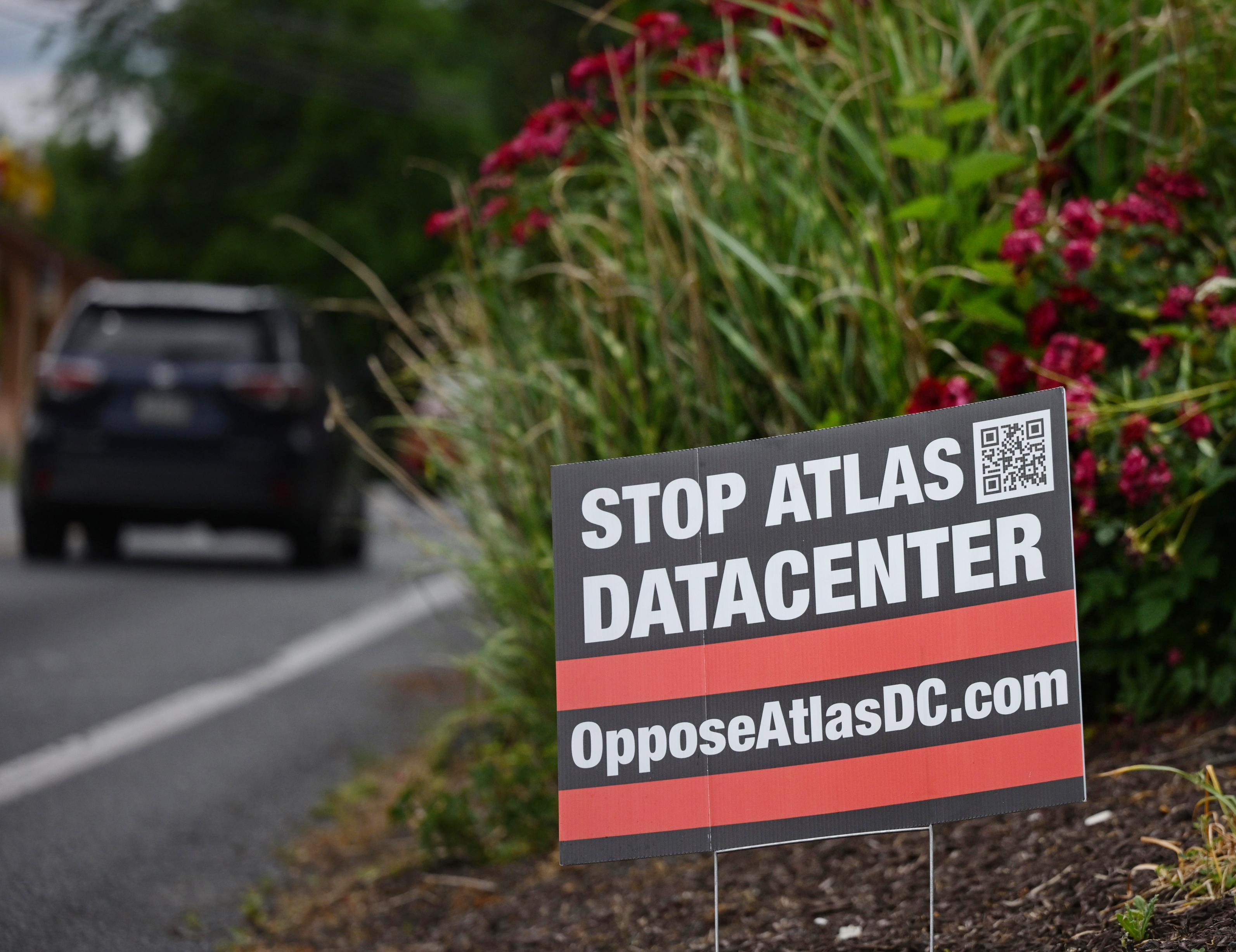 Signs opposing the Atlas Data Center line the roads Monday,...