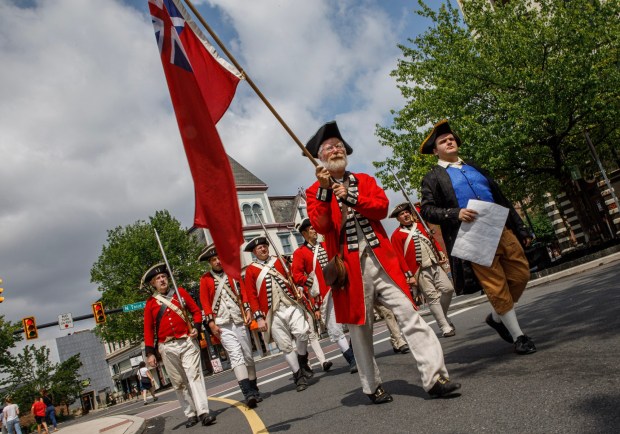 Doug Burton of Seemsville leads reenactors dressed as British troops through Centre Square on Heritage Day, Saturday, July 12, 2025, in Easton. Heritage Day showcases local and regional history with reenactment events, recreational activities and musical performances. (Jane Therese/Special to The Morning Call)