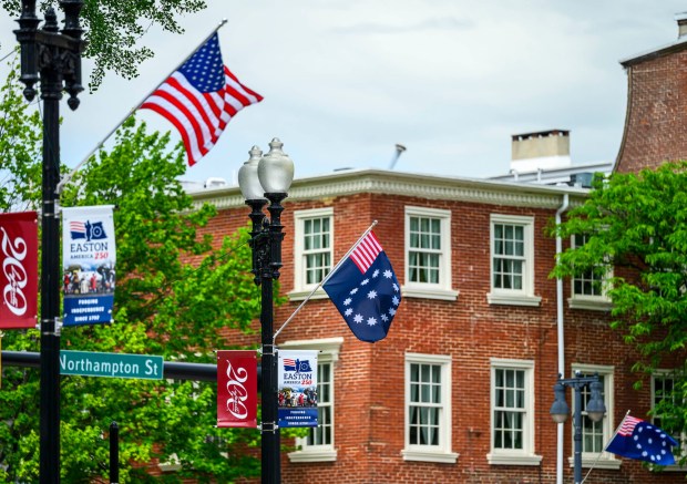 American flags and banners wave in the wind during a Thursday, May 28, 2026, news conference in Easton hosted by Lehigh Valley 250. The organization announced it would receive support from the Pennsylvania Tourism Office for regional programming tied to the 250th anniversary of the founding of the United States. (April Gamiz/The Morning Call)