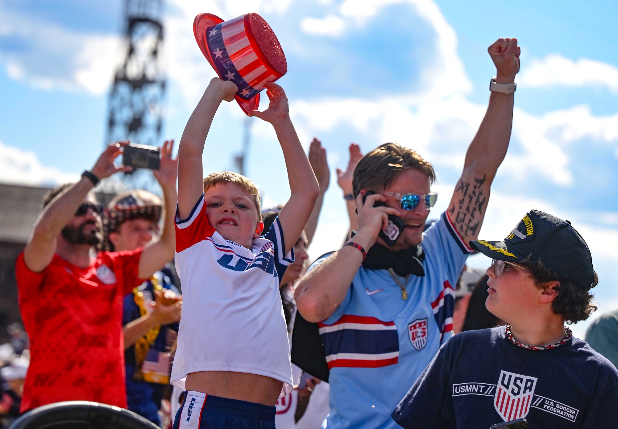 Conner Bullen, 6, of Bethlehem, holds his hat up high on Friday, June 19, 2026, after he watches the United States defeat Australia 2-0 to reach World Cup knockouts at the Lehigh Valley SoccerFest and Viewing Party at SteelStacks in Bethlehem. (Monica Cabrera/The Morning Call)