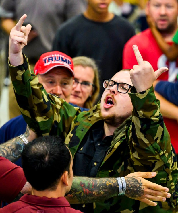 A protester is rushed out while President Donald J. Trump speaks Tuesday, June 23, 2026, at Mack Truck in Lower Macungie Township. (April Gamiz/The Morning Call)