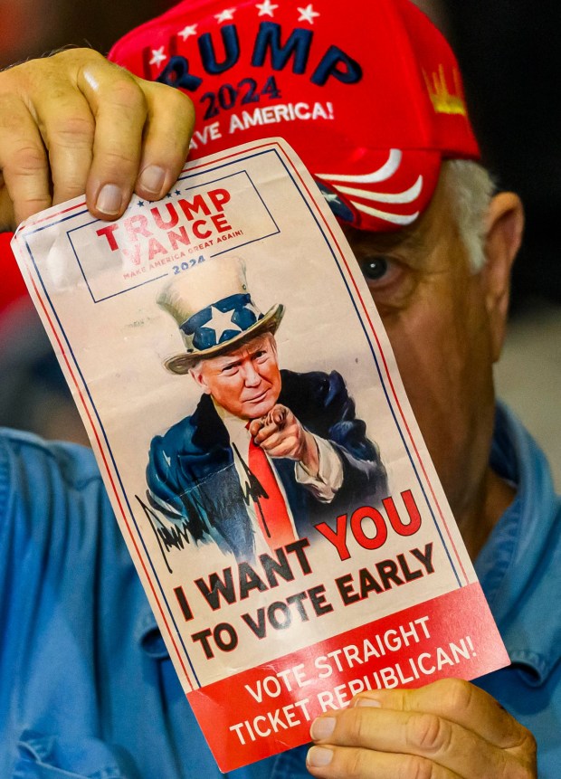 A supporter holds a poster Tuesday, June 23, 2026, before President Donald J. Trump takes the stage at Mack Truck in Lower Macungie Township. (April Gamiz/The Morning Call)