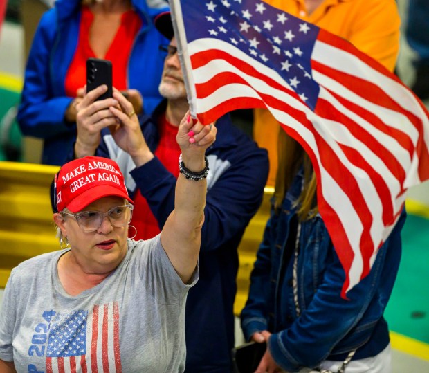 A supporter waves an American flag as President Donald J. Trump speaks Tuesday, June 23, 2026, at Mack Truck in Lower Macungie Township. (April Gamiz/The Morning Call)