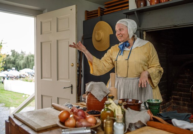 Joanne Ritter, a tour guide for Historic Bethlehem Museum and Sites, gives a demonstration of Colonial-era cooking during the Blueberry Festival on Saturday July 19, 2025, at the Burnside Plantation in Bethlehem. (Jane Therese/Special to The Morning Call)