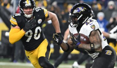 Jan 4, 2026; Pittsburgh, Pennsylvania, USA; Baltimore Ravens running back Derrick Henry (22) rushes the ball past Pittsburgh Steelers linebacker T.J. Watt (90) during the first half at Acrisure Stadium.
