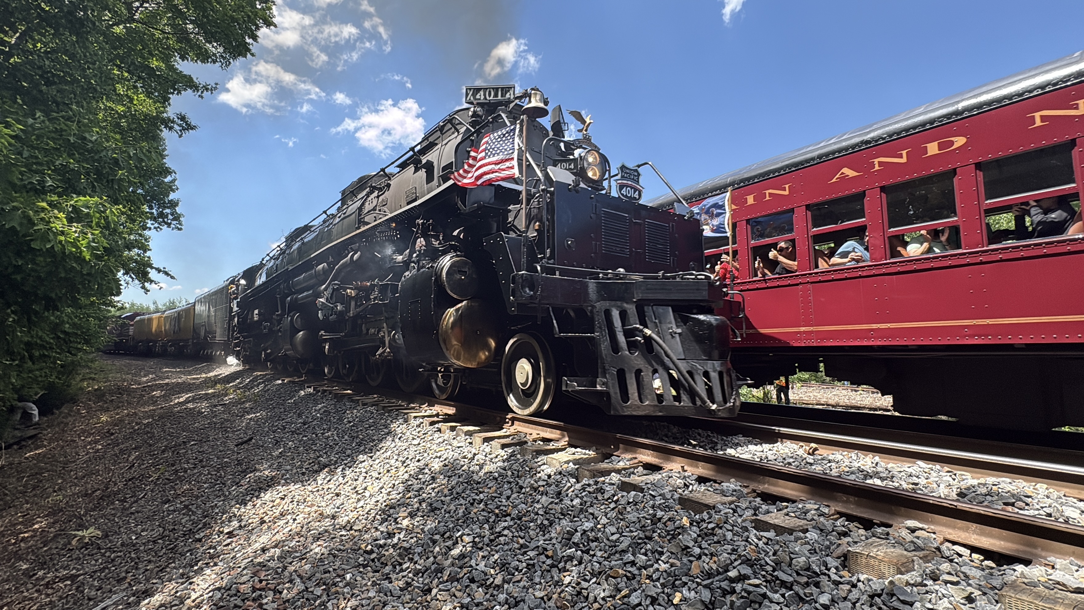 Union Pacific’s Big Boy 4014 runs parallel to passenger cars...