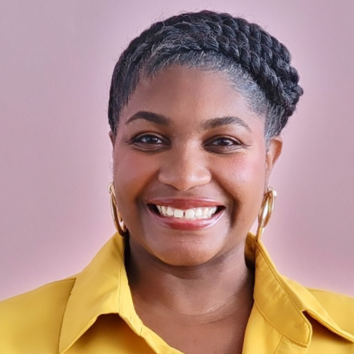 A woman with braided hair smiles at the camera, wearing a yellow collared shirt and gold hoop earrings, against a light pink background.