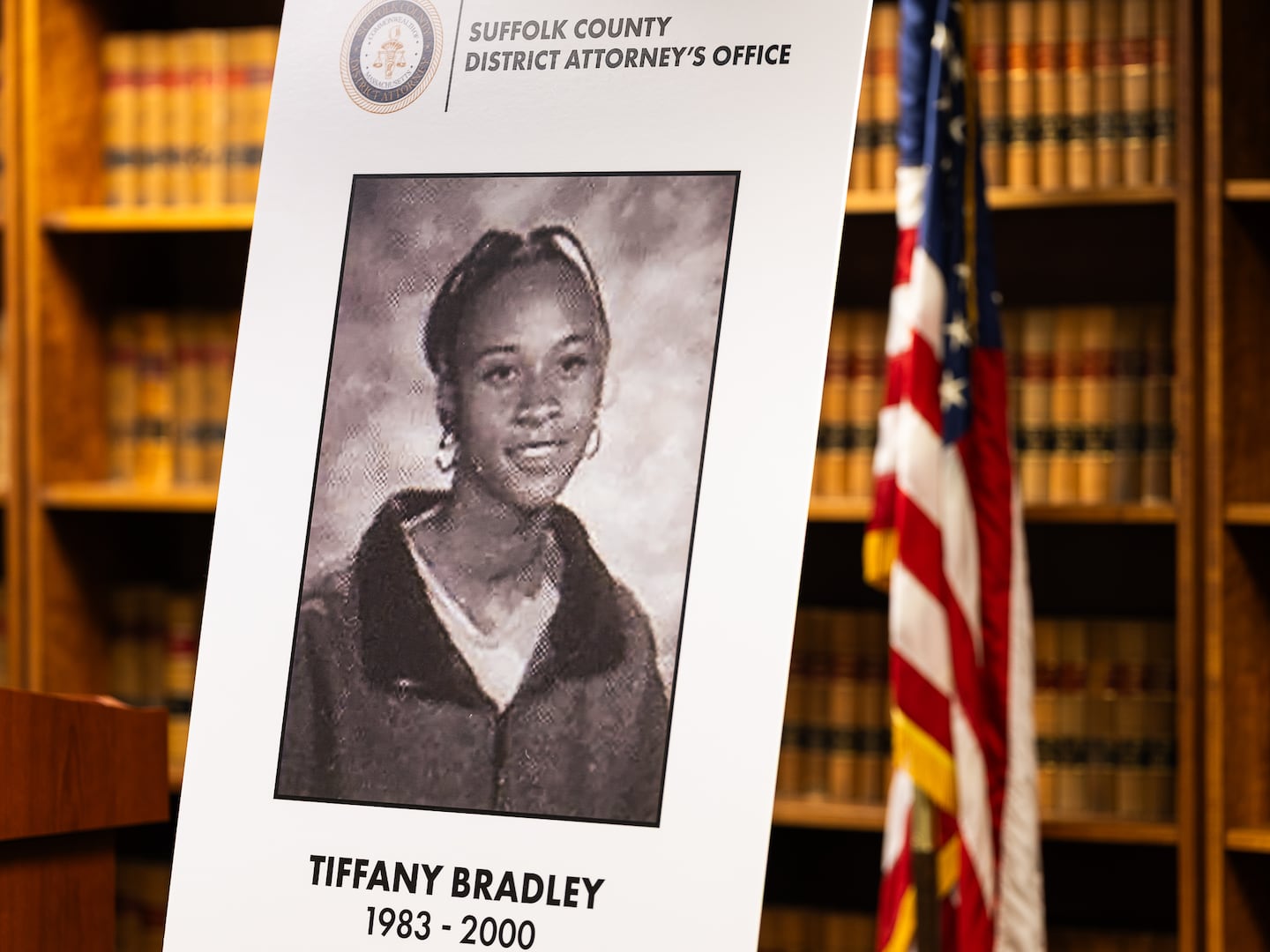 A poster with a photo of Tiffany Bradley was displayed before a press conference at the Suffolk County district attorney’s office in Boston on Wednesday.