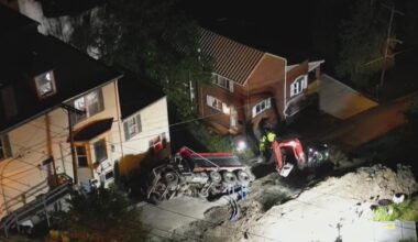 Dump truck backing down road falls into hole in Pittsburgh's Mount Washington neighborhood
