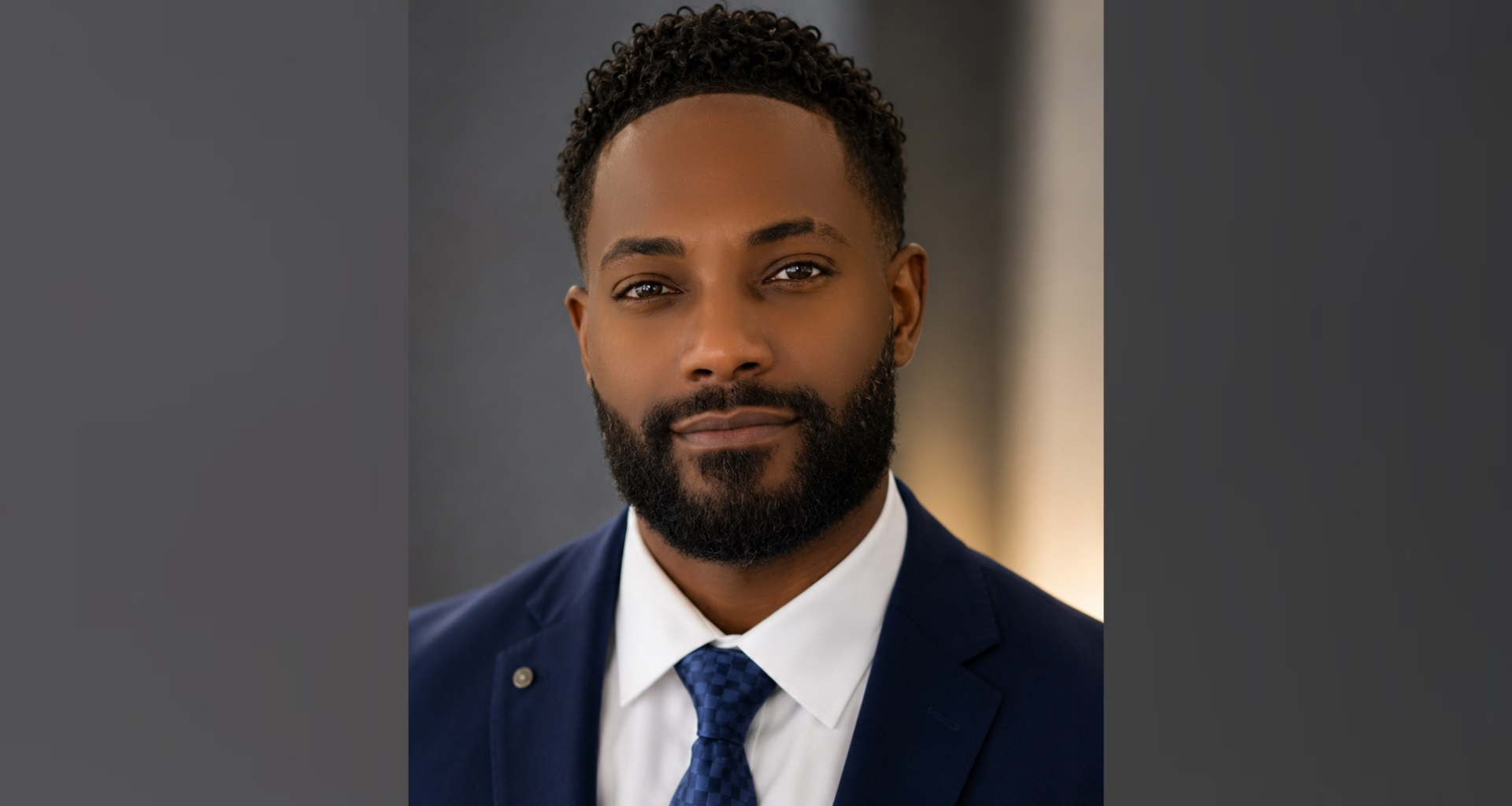 Michael Cooley, who said he plans to run for Bethlehem City Council in 2027, poses for a headshot in a navy suit and blue tie.
