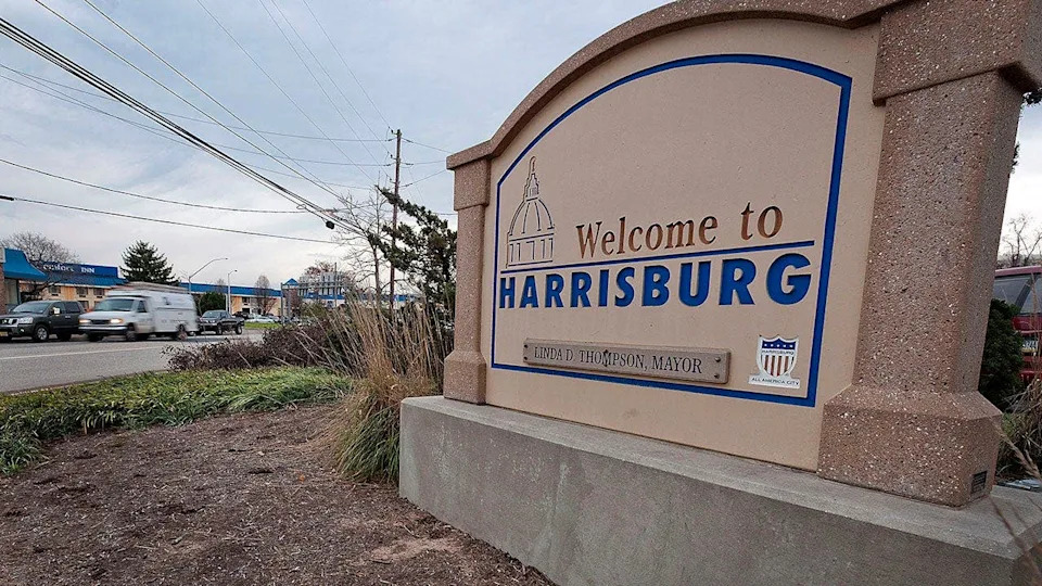 A welcome sign standing in Harrisburg, Pennsylvania, outdoors.