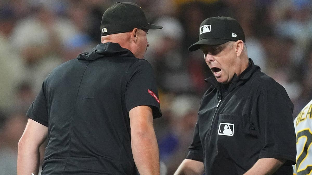 Pittsburgh Pirates manager Don Kelly arguing with umpire Todd Tichenor on baseball field