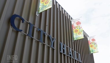 An exterior wall of a builing with signage reading City Hall.