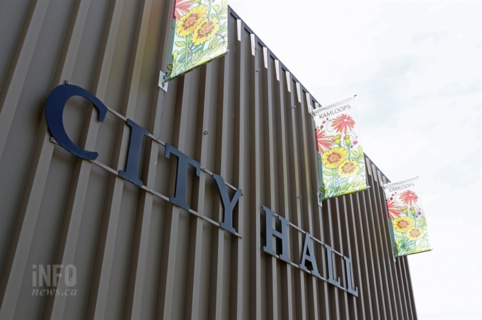 An exterior wall of a builing with signage reading City Hall.