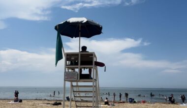 A lifeguard at Edgewater Beach watching people swim. (Spectrum News 1)