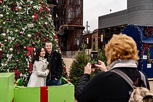 Bethlehem, PA, USA - December 9, 2018: Visitors pose for a photo at the Christkindlmarket. The Christmas market is held at Steel Stacks, a campus that hosts festivals, concerts & events.