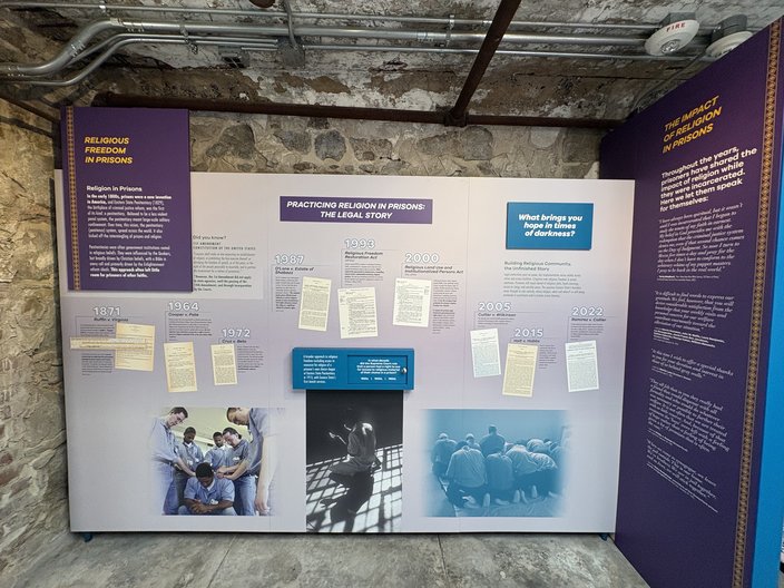 Purple museum exhibit panel on the legal history of religious freedom in prisons