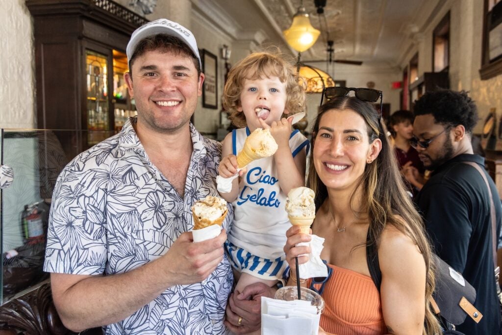 Jaron and Lisa Theis appear alongside 3-year-old Henry, holding ice cream cones at Franklin Fountain in Old City, Philadelphia
