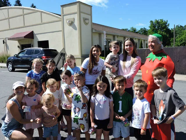 <p>Borough Council President Gerrie Carey, dressed as a strawberry, visits with young Summer Solstice & Strawberry Festival attendees.</p>
<p>Submitted Photo</p>
