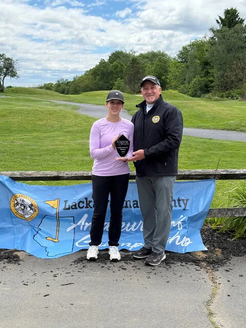 <p>Brianna Moffatt of Abington Heights won her second straight Lackawanna County Amateur Tourney Girls Junior Division title with a score of 81. Tournament Director Mark Cordelli presented her with a trophy at Pine Hills Country Club in Taylor in late May.</p>
<p>Submitted Photo</p>
