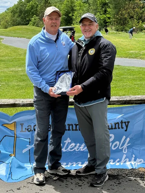 <p>Bob Andrejko, left, accepts his trophy from Lackawanna County Amateur Golf Tournament Director Mark Cordelli for winning the Senior Division with a four-under-par 67. Seventy-five golfers participated in the late-May event at Pine Hills Country Club, Taylor.</p>
<p>Submitted Photo</p>