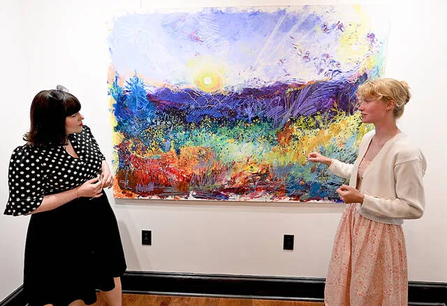 <p>Artist Leanna Yatchilla, right, explains the process behind one of her pieces on display at Art e Fekts Gallery, to art admirer Sheena Dalley.</p>
<p>Tony Callaio | For Sunday Dispatch</p>