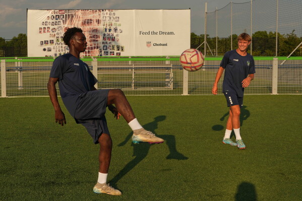 Pennsylvania Classic players Moussa Oumarou, left, and Liam Gustafson, right, juggle the ball before training at the club were U.S. national team soccer player, Christian Pulisic, honed his skills in Manheim, Pa., on Monday, June 29, 2026. (AP Photo/Luis Andres Henao)