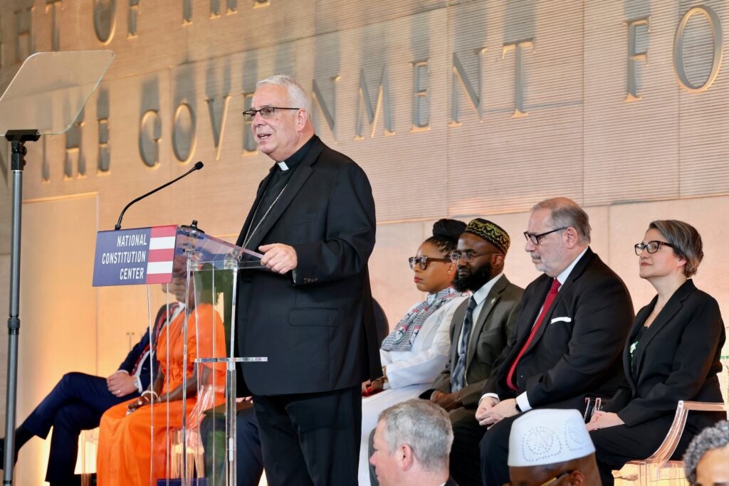 Nelson J. Pérez speaking at a podium.