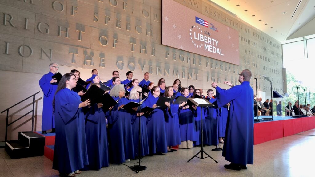 The Archdiocesan Choir of Philadelphia and the Choir of the Cathedral Basilica of Saints Peter and Paul singing on stage.
