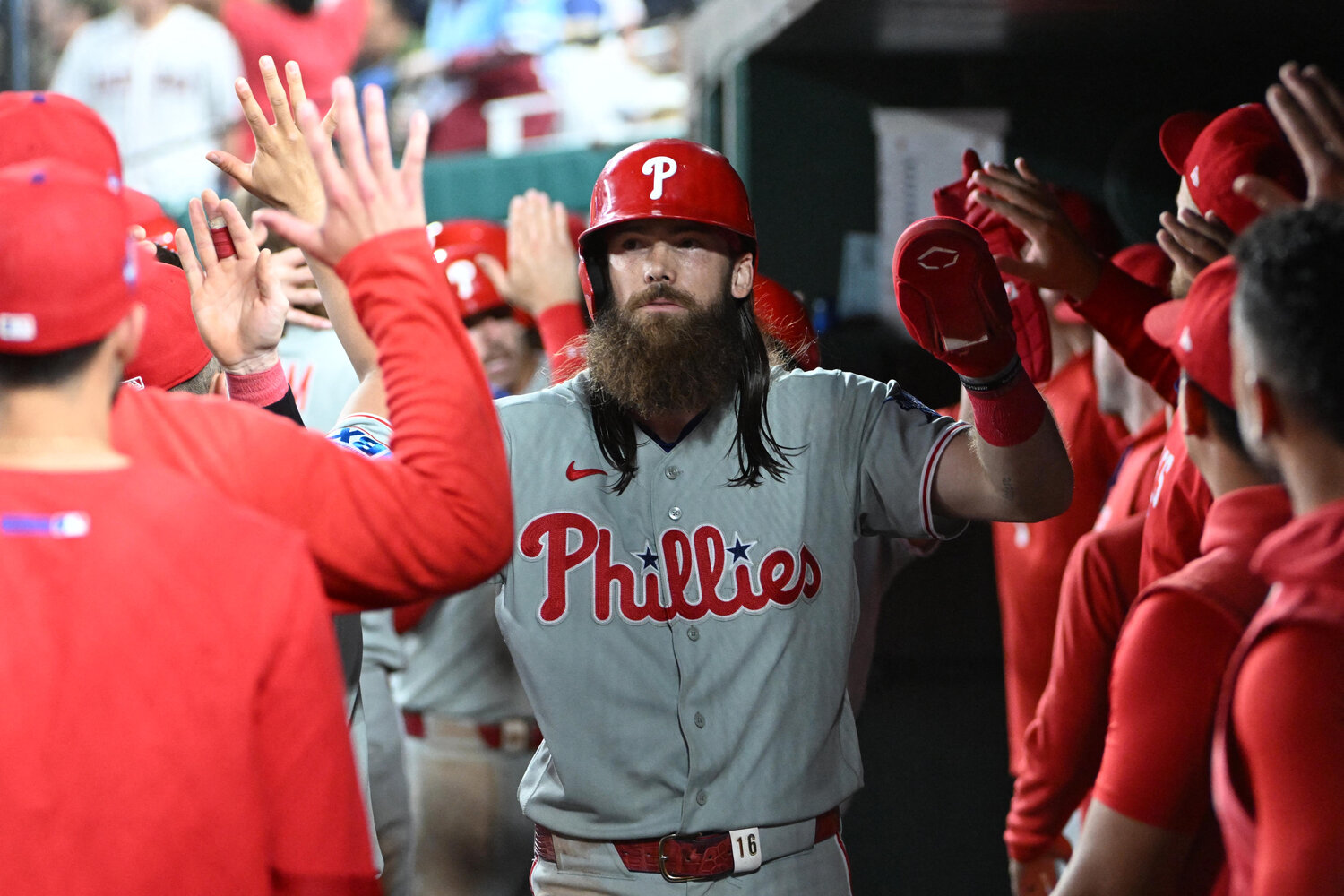 Philadelphia Phillies left fielder Brandon Marsh (16) is congratulated by teammates after scoring a run during the eighth inning at Nationals Park.