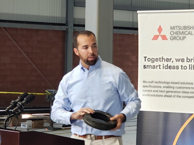 Bryan Robinson, technical sales manager for Mitsubishi Chemical, shows some of the company's products made from plastic pellets. The advanced stock shapes are used by customers to create specialized components. (MICHELLE LYNCH/READING EAGLE)