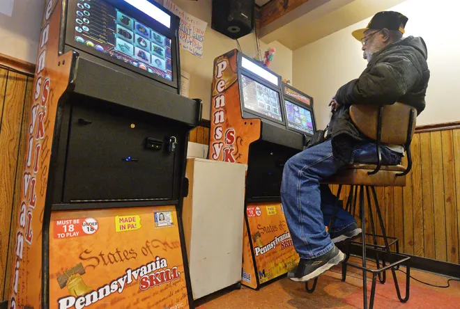 A customer plays a Pennsylvania Skills game inside American Legion Post 771 in Erie. Pennsylvania Attorney General Dave Sunday's office estimates there are 70,000 such games in operation in the state.