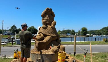 Sand sculptors Carl Jara and Greg J. Grady work on a sand sculpture ahead of the 2nd Lake Erie Sand Sculpture Tour in Lake County.