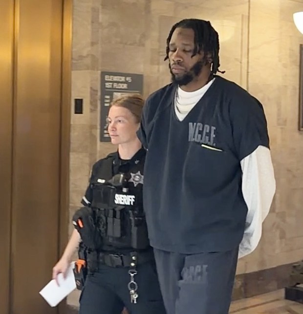 Quron Carter is escorted by a deputy sheriff from a Montgomery County courtroom to begin 9-18 year prison term for straw purchase scheme. (Photo by Carl Hessler Jr. - MediaNews Group)