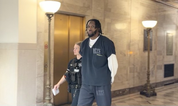Quron Carter is escorted by a deputy sheriff from a Montgomery County courtroom to begin 9-18 year prison term for straw purchase scheme. (Photo by Carl Hessler Jr. - MedianNews Group)
