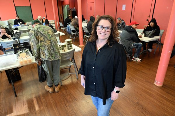 Christie Botterbusch, executive director of New Journey Community Outreach, stands in the dining area at 138 S. Sixth St. The soup kitchen, food pantry and clothes outreach hopes to expand as a designated day center, serving Berks County's unhoused population. (BILL UHRICH - READING EAGLE)