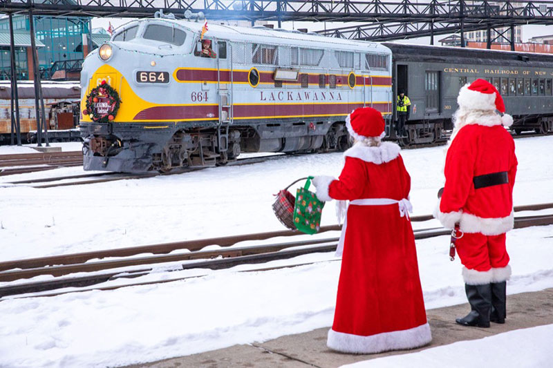 Santa and Mrs. Claus wave to a departing train at Styeamtown National Historic Site in Scranton, PA.