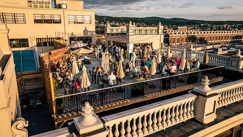Rooftop crowd enjoying skyline views above downtown at The Roof at Oppenheim in Scranton, PA.