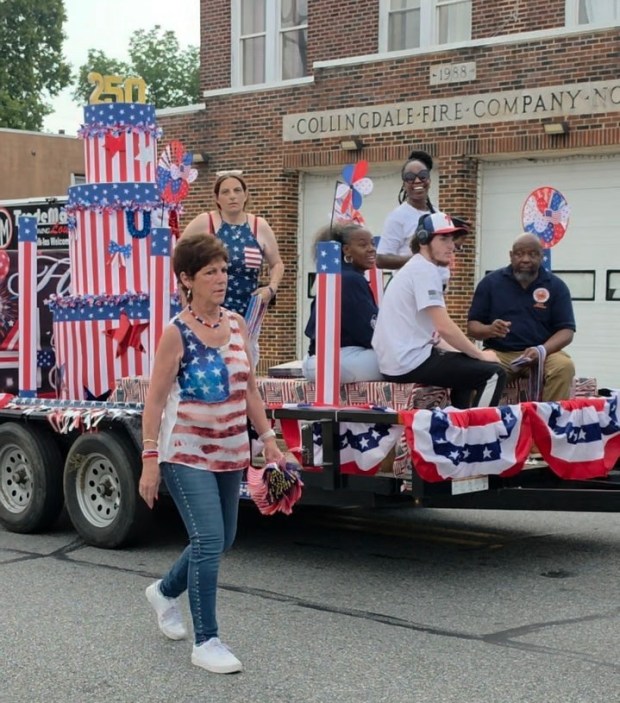 In this year's Independence Day Parade on July 11, Collingdale Mayor Donna Matteo-Spadea walks beside a float holding, left to right, council members Shannon Murphy, Felecia Coffee, Fareeda Mabry and Dwight Green, as well as Murphy's son, Sean Murphy. (COURTESY OF JOY WINNER)