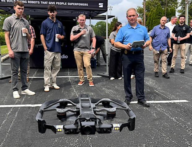 Upper Chichester Police Lt. Christopher Jones, holding controller, test flies a Skydio drone in the police station parking lot. (PETE BANNAN-DAILY TIMES)