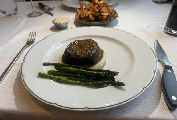 Steak Diane, served with a side of asparagas, is covered in shallot, cognac and mushroom cream sauce. (PEG DEGRASSA/ DAILY TIMES)