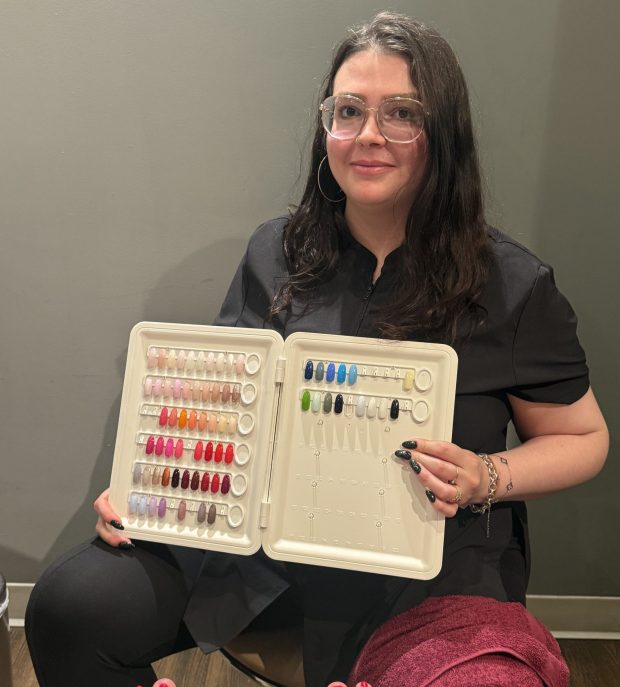 Nail tech Brianna Grey holds up an assortment of gel nail polish colors for a customer at The Rittenhouse Spa and Salon, located inside the historic Rittenhouse Hotel. (PEG DEGRASSA/ DAILY TIMES)