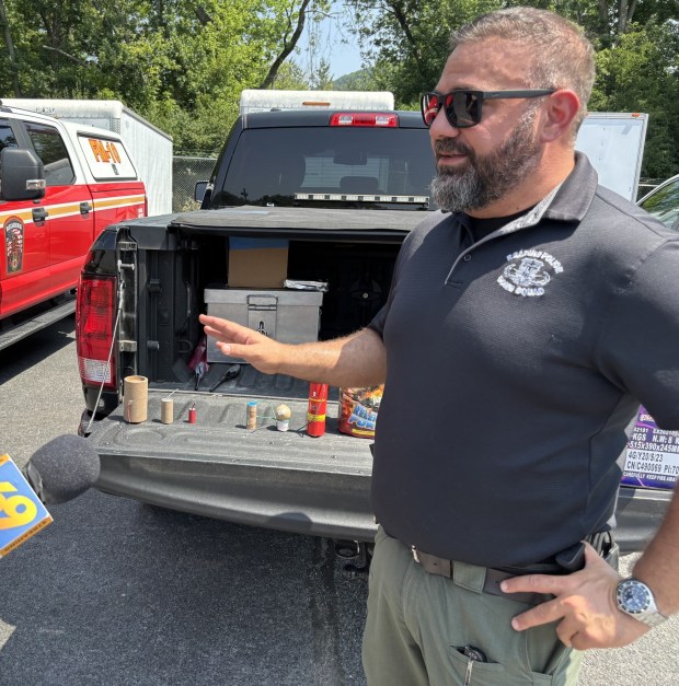 Reading police Lt. Nick Epolito, bomb squad commander, says mortars on the right side of the tailgate may be legal fireworks, but need to be handled with extreme care if they misfire. On the left side the tailgate are three illegal fireworks, which are essentially explosive devices in cardboard coverings. (STEVEN HENSHAW - READING EAGLE)