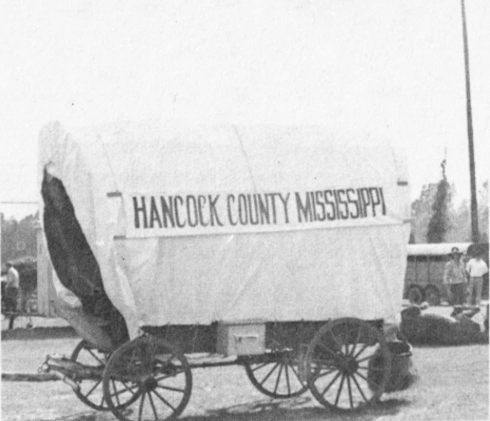 Hugo Favre Jr. and his family rode in a covered wagon donned "Hancock County, Mississippi" all...