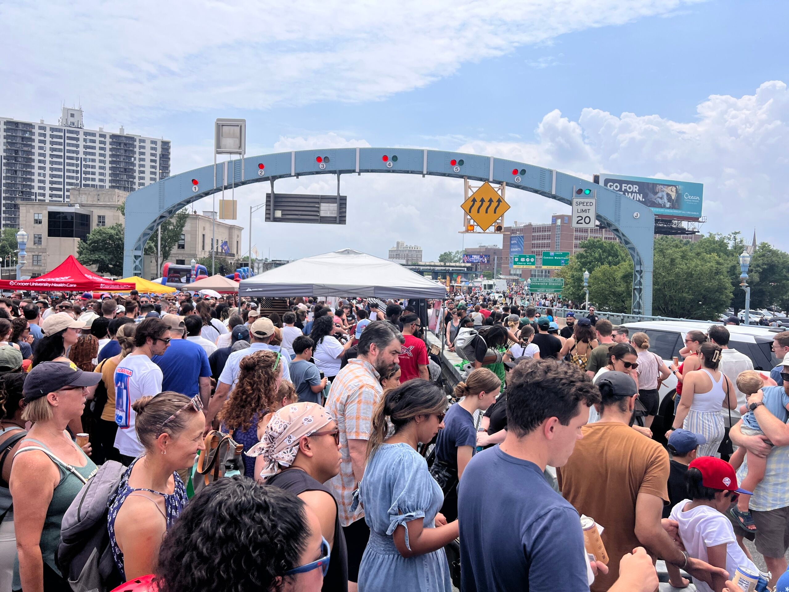 Thousands of people walked over the Ben Franklin Bridge on Saturday, July 11th to celebrate the 100th birthday of the Ben Franklin Bridge. Here is a photo of people turning right to attempt to hop over the median to avoid the crowded Camden side of the bridge. Absolutely packed.