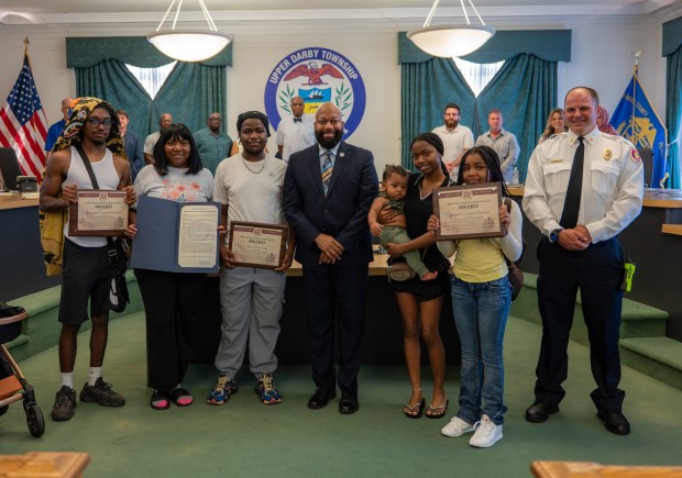 The Jackson family with Mayor Ed Brown and Fire Chief Nick Martin. (COURTESY OF UPPER DARBY TOWNSHIP)