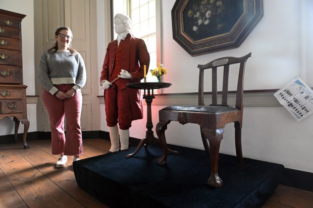 Anna E. Meitlzer, museum educator at Pottsgrove Manor, stands with a chair that belonged to Isaac Potts and was believed that George Washington had sat in it at Potts' home in Valley Forge. (BILL UHRICH/READING EAGLE)