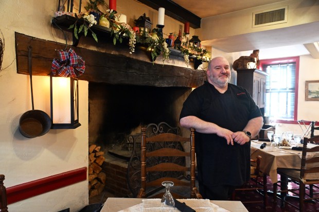 Matthew DeSantis, manager at the Stouch Tavern, stands by a fireplace in front of which George Washington may have warmed himself when he stayed overnight on Nov. 13, 1793, after inspecting locks on the Union Canal. (BILL UHRICH/READING EAGLE)