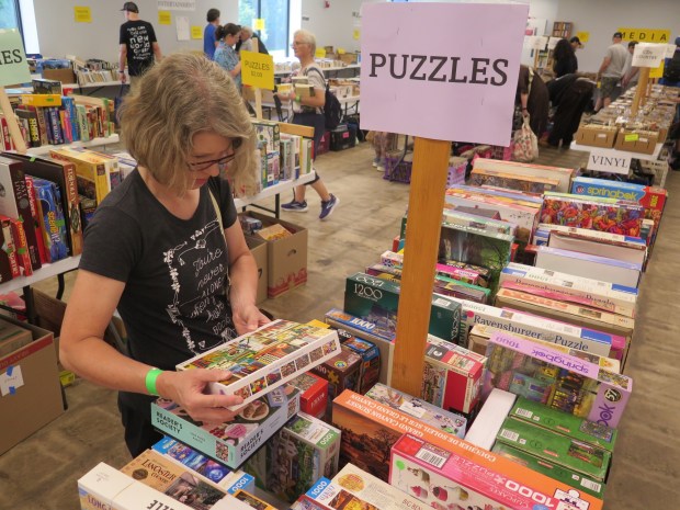 Emily Amberman headed to the opening day of the Berks Book Bonanza on Wednesday to add books to her personal library and puzzles to libraries at schools in York County where she works. (DAVID MEKEEL - READING EAGLE)